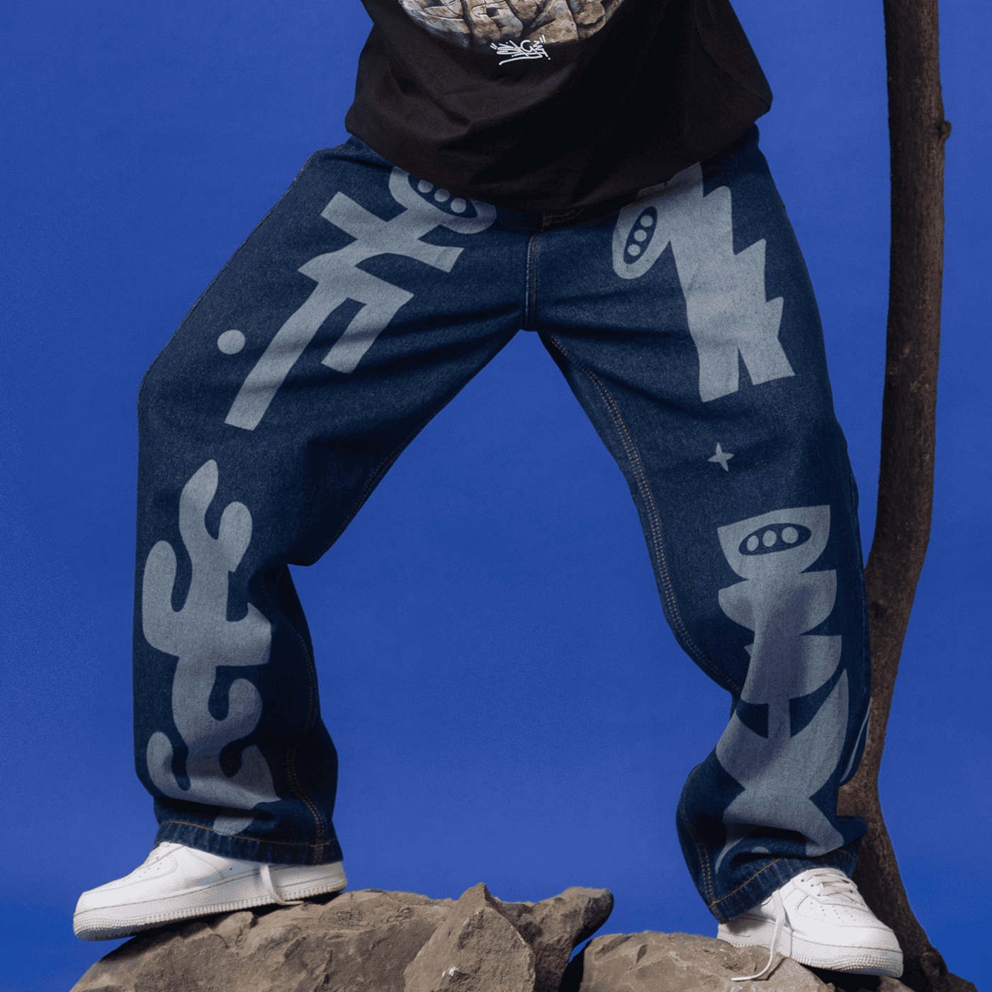 Model wearing Ozo 'Sage' denim pants, front view